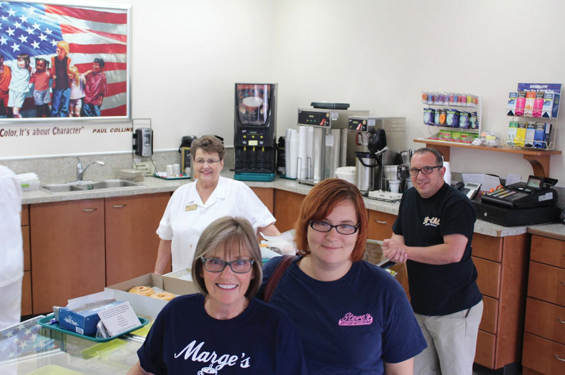 Marge Wilson, owner of Marge’s Donut Den, behind my wife Carol and our hosts Missy and Steve Sturim