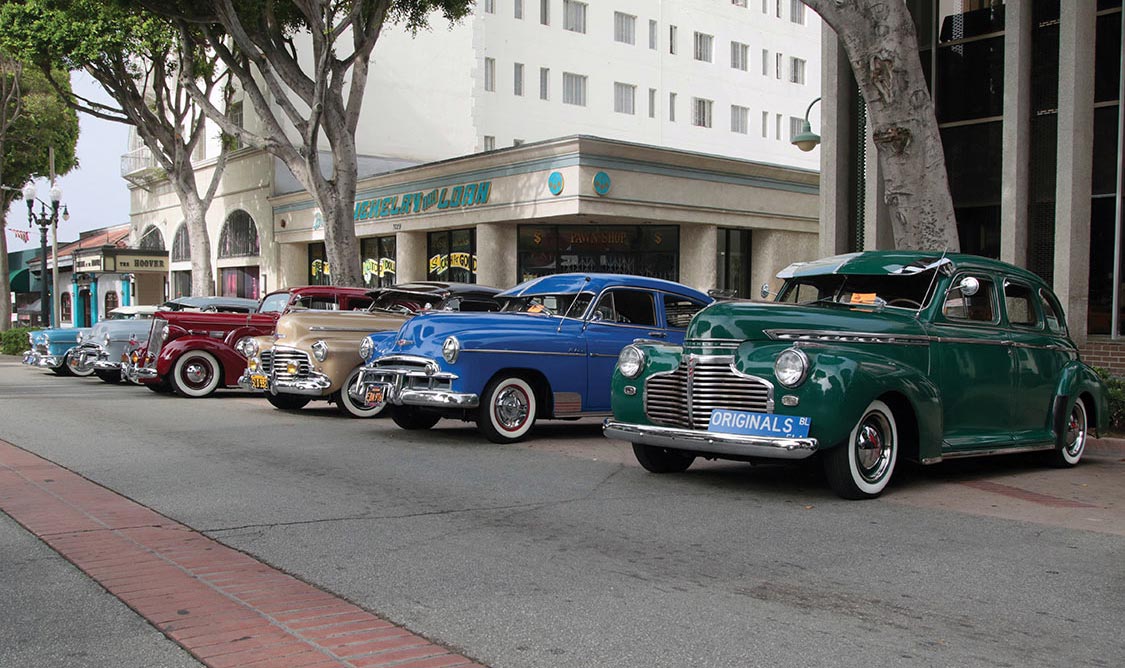 vintage cars staged along the street for event